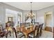 Spacious dining room with hardwood floors, a chandelier, and seamless flow to other living areas, great for entertaining at 2310 Gracehaven Way, Lawrenceville, GA 30043