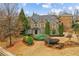 Stunning two-story brick home with a beautifully landscaped front yard featuring a variety of lush plants and trees at 2310 Gracehaven Way, Lawrenceville, GA 30043