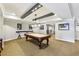 Basement game room featuring a pool table under stylish pendant lighting and bar seating at 2310 Gracehaven Way, Lawrenceville, GA 30043