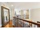 Hallway with hardwood flooring and wrought iron banister at 2310 Gracehaven Way, Lawrenceville, GA 30043