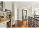 Second floor hallway features hardwood floors, mirror and built-in desk at 2310 Gracehaven Way, Lawrenceville, GA 30043
