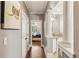Hallway with hardwood floors leading to the bathroom and a bedroom with lots of light at 2310 Gracehaven Way, Lawrenceville, GA 30043
