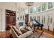 Open living room boasts a fireplace, built-in shelving, and a grand piano at 2310 Gracehaven Way, Lawrenceville, GA 30043