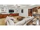 Basement living room featuring a comfortable sofa and a wet bar with wood cabinetry at 2310 Gracehaven Way, Lawrenceville, GA 30043