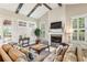 Bright and airy living room boasts a fireplace, large windows, and hardwood floors at 2310 Gracehaven Way, Lawrenceville, GA 30043