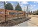 Stonehaven neighborhood entrance with brick sign, manicured landscaping, and sidewalk at 2310 Gracehaven Way, Lawrenceville, GA 30043