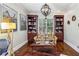 Cozy home office featuring built-in bookcases and hardwood floors at 2310 Gracehaven Way, Lawrenceville, GA 30043