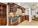 The basement wet bar features custom cabinets, a granite countertop, and a stainless steel microwave and wine cooler at 2310 Gracehaven Way, Lawrenceville, GA 30043
