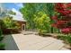 Wonderful patio space featuring stone pavers and a wooden deck, framed by lush landscaping at 1790 Mountain Farm Rd, Woodstock, GA 30188
