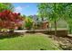 Landscaped backyard with wooden deck and lush greenery for outdoor enjoyment at 1790 Mountain Farm Rd, Woodstock, GA 30188