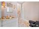 Elegant bathroom with marble floors, a stylish gold sink, and unique light fixtures at 1790 Mountain Farm Rd, Woodstock, GA 30188