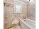 Relaxing bathroom featuring a soaking tub and neutral tile at 1790 Mountain Farm Rd, Woodstock, GA 30188
