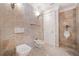 Spacious bathroom features a toilet, bidet, and urinal with beige tiling throughout at 1790 Mountain Farm Rd, Woodstock, GA 30188