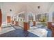 Covered patio with brick columns, white railings, and a view of the wooded backyard at 1790 Mountain Farm Rd, Woodstock, GA 30188