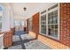 Spacious covered patio featuring brick accents and views of the natural surroundings at 1790 Mountain Farm Rd, Woodstock, GA 30188
