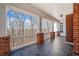 Covered patio with beautiful brick columns and a peaceful view of the surrounding trees at 1790 Mountain Farm Rd, Woodstock, GA 30188