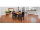 Dining room with hardwood floors, seating for four, large mirror and views into kitchen at 1790 Mountain Farm Rd, Woodstock, GA 30188