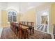 Bright dining room featuring a long table and chairs with a chandelier above at 1790 Mountain Farm Rd, Woodstock, GA 30188