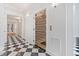 Hallway showcasing elevator with metal gate and black and white checkered flooring at 1790 Mountain Farm Rd, Woodstock, GA 30188