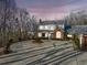 Charming two-story home boasts a large driveway and manicured greenery at 1790 Mountain Farm Rd, Woodstock, GA 30188