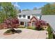 Charming two-story home with a manicured front yard and circular driveway at 1790 Mountain Farm Rd, Woodstock, GA 30188