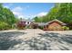 Expansive brick home featuring an extensive driveway and lush landscaping at 1790 Mountain Farm Rd, Woodstock, GA 30188