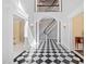 Elegant foyer with black and white checkered floors and a staircase at 1790 Mountain Farm Rd, Woodstock, GA 30188