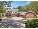 Elegant brick home with a circular driveway and lush landscaping at 1790 Mountain Farm Rd, Woodstock, GA 30188