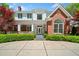 Beautiful home with brick and white facade, manicured landscaping, and a welcoming entrance at 1790 Mountain Farm Rd, Woodstock, GA 30188