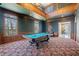 Spacious game room with a pool table, wood paneled walls, and ample lighting at 1790 Mountain Farm Rd, Woodstock, GA 30188