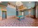 Game room featuring custom woodwork, spiral staircase, large windows, and a pool table, offering both style and functionality at 1790 Mountain Farm Rd, Woodstock, GA 30188