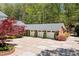 Spacious three-car garage with a wide driveway and well-maintained landscaping at 1790 Mountain Farm Rd, Woodstock, GA 30188