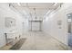 Large garage with concrete floors, utility sink, and ample lighting at 1790 Mountain Farm Rd, Woodstock, GA 30188
