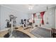 A well-equipped home gym featuring modern exercise equipment and a ceiling fan at 1790 Mountain Farm Rd, Woodstock, GA 30188