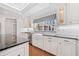Bright kitchen features white cabinetry, granite countertops, and stainless steel appliances at 1790 Mountain Farm Rd, Woodstock, GA 30188