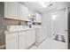 Well-organized laundry room with modern washer and dryer and ample storage space at 1790 Mountain Farm Rd, Woodstock, GA 30188