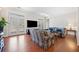 Living room with hardwood floors, french doors, large TV and views of the exterior at 1790 Mountain Farm Rd, Woodstock, GA 30188