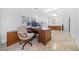 Home office with an executive desk, multiple monitors, and abundant natural light at 1790 Mountain Farm Rd, Woodstock, GA 30188