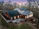 Expansive rear exterior showing brick accents, lush yard, and elevated location at 1790 Mountain Farm Rd, Woodstock, GA 30188