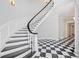 Grand foyer showcasing a sweeping staircase with a black and white checkered floor at 1790 Mountain Farm Rd, Woodstock, GA 30188