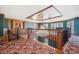 Upper room with custom woodwork, built-in shelves, and a large window offering natural light, providing a versatile area at 1790 Mountain Farm Rd, Woodstock, GA 30188