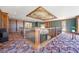 Open upper room featuring custom woodwork, built-in bookshelves, and unique ceiling design, adding character to the space at 1790 Mountain Farm Rd, Woodstock, GA 30188