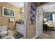 Bathroom featuring a marble vanity, with a toilet and doorway that leads into the primary bedroom at 2626 Peachtree Nw Rd # 704, Atlanta, GA 30305