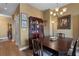 This is a dining room with a dark wood table and chairs, a china cabinet, and a chandelier at 2626 Peachtree Nw Rd # 704, Atlanta, GA 30305