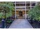Building entrance surrounded by lush greenery and landscaping at 2626 Peachtree Nw Rd # 704, Atlanta, GA 30305