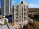 High-rise condo building features private balconies and multiple windows with colorful autumn trees surrounding the building at 2626 Peachtree Nw Rd # 704, Atlanta, GA 30305
