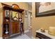 Hallway and foyer space with a decorative wooden cabinet, tiled floor, and decor to add character to the home at 2626 Peachtree Nw Rd # 704, Atlanta, GA 30305