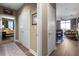 Hallway connecting to the bedroom and living room with hardwood floors, neutral walls, and a stylish, patterned rug at 2626 Peachtree Nw Rd # 704, Atlanta, GA 30305