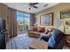 Inviting living room with a large window, comfortable seating, and a picturesque view of the outdoor trees at 2626 Peachtree Nw Rd # 704, Atlanta, GA 30305