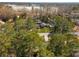 A quaint house with a well-manicured lawn and proximity to a lake, viewed from above at 2542 Maclaren Cir, Dunwoody, GA 30360